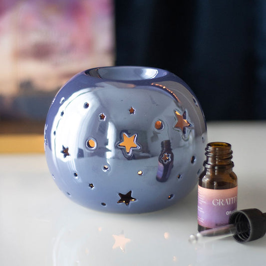 Quemador para aceite y cera en color iridiscente/tornasol morado con estrellas